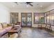 Spacious living room with tiled floors, ample seating, and elegant French doors leading outdoors at 7640 E Poinsettia Dr, Scottsdale, AZ 85260