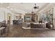 Open-concept living room with stone fireplace, kitchen, and bar area, perfect for entertaining at 7640 E Poinsettia Dr, Scottsdale, AZ 85260