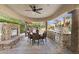 Picturesque outdoor living featuring a fireplace, built-in grill, and dining area by the pool at 7640 E Poinsettia Dr, Scottsdale, AZ 85260