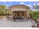 Inviting outdoor space with stone pillars, built-in grill, and cozy fireplace for delightful entertaining at 7640 E Poinsettia Dr, Scottsdale, AZ 85260