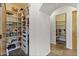 Spacious pantry with open shelves, drawers, and unique tile flooring in a well-lit space at 7640 E Poinsettia Dr, Scottsdale, AZ 85260