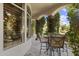 Outdoor patio with a stone floor, stone table and seating surrounded by an archway of greenery at 7640 E Poinsettia Dr, Scottsdale, AZ 85260