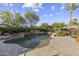 This backyard oasis has a pool with waterfall, spa, beautiful desert landscaping, and an outdoor lounge area at 7640 E Poinsettia Dr, Scottsdale, AZ 85260