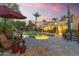 Resort-style backyard featuring a sparkling pool, lush landscaping, mature palms and plenty of space for relaxation and entertaining at 7640 E Poinsettia Dr, Scottsdale, AZ 85260