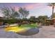Resort-style pool with rock features, spa, and lush landscaping, creating a luxurious outdoor oasis at 7640 E Poinsettia Dr, Scottsdale, AZ 85260