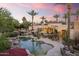 An inviting lagoon-style pool surrounded by lush landscaping, lounge chairs, and a resort-like atmosphere at 7640 E Poinsettia Dr, Scottsdale, AZ 85260