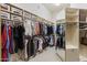 Organized walk-in closet featuring custom shelving, hanging racks, and ample storage space at 7640 E Poinsettia Dr, Scottsdale, AZ 85260