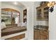 Cozy window seat with built-in storage, decorative shutters, and a granite-topped bar area at 7640 E Poinsettia Dr, Scottsdale, AZ 85260