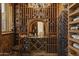 Rustic wine cellar featuring custom wood racking and a tasting area with a granite countertop at 7640 E Poinsettia Dr, Scottsdale, AZ 85260