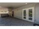 A covered patio with brick pavers provides access to the hot tub and interior of the home via double doors at 807 E San Remo Ave, Gilbert, AZ 85234