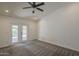 This primary bedroom features carpet, a ceiling fan and access to outdoor patio at 807 E San Remo Ave, Gilbert, AZ 85234