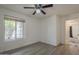 This is a bedroom with wood floors, a ceiling fan and a window to the outdoors at 807 E San Remo Ave, Gilbert, AZ 85234