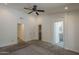 This primary bedroom features carpet, a ceiling fan, closet and bathroom access at 807 E San Remo Ave, Gilbert, AZ 85234