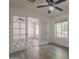 This is a bedroom that has a ceiling fan and a wooden floor with french doors at 807 E San Remo Ave, Gilbert, AZ 85234