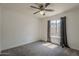 Comfortable bedroom with neutral carpet, a window for natural light, and a ceiling fan at 807 E San Remo Ave, Gilbert, AZ 85234