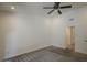 This is a carpeted bedroom with a ceiling fan and a door to the ensuite bath at 807 E San Remo Ave, Gilbert, AZ 85234