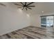 Bright bonus room features wood-look floors, fresh white walls, ample natural light, and a sliding glass door at 807 E San Remo Ave, Gilbert, AZ 85234
