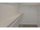 Walk-in closet with shelving and rod for storage with neutral carpeted floors at 807 E San Remo Ave, Gilbert, AZ 85234