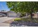 Inviting front exterior featuring a well-manicured lawn, shade tree, and convenient two-car garage at 807 E San Remo Ave, Gilbert, AZ 85234
