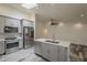 Open concept kitchen with stainless steel appliances, island, and a clear view into the adjacent living space at 807 E San Remo Ave, Gilbert, AZ 85234