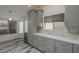 Well-lit kitchen featuring gray cabinetry, stainless steel appliances, and white marble countertops at 807 E San Remo Ave, Gilbert, AZ 85234