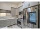 Bright kitchen featuring gray cabinetry, stainless steel appliances, and white marble countertops at 807 E San Remo Ave, Gilbert, AZ 85234