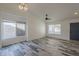 Bright living room features wood-look floors, fresh white walls, ample natural light, and a ceiling fan at 807 E San Remo Ave, Gilbert, AZ 85234