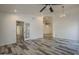 Bright open-concept living room featuring fresh white walls, wood-look floors, and access to other rooms at 807 E San Remo Ave, Gilbert, AZ 85234
