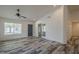 Bright living room features wood-look floors, fresh white walls, ample natural light, and a ceiling fan at 807 E San Remo Ave, Gilbert, AZ 85234