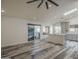 Bright living room featuring wood-look floors open to kitchen with a large sliding glass door to the outside at 807 E San Remo Ave, Gilbert, AZ 85234