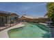 Relaxing pool features a safety fence for protection, desert landscaping, and view of the home at 807 E San Remo Ave, Gilbert, AZ 85234