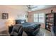 Bright bedroom features a decorative ceiling fan, light pink paint, and a large bookshelf at 8787 E Mountain View Rd # 1110, Scottsdale, AZ 85258