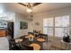 Dining room with ceiling fan, shuttered windows, and view into the kitchen at 8787 E Mountain View Rd # 1110, Scottsdale, AZ 85258