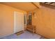 Inviting condo front entrance with a charming wooden bench, fresh paint, and ample natural light at 8787 E Mountain View Rd # 1110, Scottsdale, AZ 85258