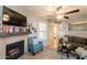 Living room with a tiled fireplace, mantel, neutral walls, wood flooring, and decor at 8787 E Mountain View Rd # 1110, Scottsdale, AZ 85258