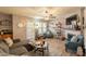 Cozy living room featuring a decorative ceiling fan, a fireplace, and built-in bookshelves at 8787 E Mountain View Rd # 1110, Scottsdale, AZ 85258