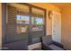 Patio with two chairs, windows looking out, and light yellow exterior paint at 8787 E Mountain View Rd # 1110, Scottsdale, AZ 85258