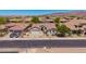 An aerial showcases a well-maintained home with tile roof, desert landscaping, and neighborhood view at 9623 S 25Th Ln, Phoenix, AZ 85041