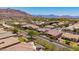 Aerial neighborhood view showcasing lush landscaping, well-maintained homes, and stunning mountain backdrop at 9623 S 25Th Ln, Phoenix, AZ 85041