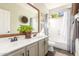 Bathroom featuring a double sink vanity, tile floors, tub-shower combo, and attractive mirror at 9623 S 25Th Ln, Phoenix, AZ 85041