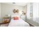Cozy bedroom with a white bed, modern furnishings, natural light, and wood-look floors at 9623 S 25Th Ln, Phoenix, AZ 85041