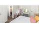 Bright bedroom featuring a bed, vanity, stylish decor, wood-look floors, and natural light at 9623 S 25Th Ln, Phoenix, AZ 85041