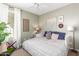 Bedroom featuring neutral walls, wood-look flooring, a window, and attractive decor at 9623 S 25Th Ln, Phoenix, AZ 85041