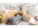 Comfortable bedroom showcases charming decor, neutral walls, wood-look flooring, and natural light at 9623 S 25Th Ln, Phoenix, AZ 85041