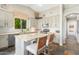 Stylish kitchen featuring stone countertops, updated appliances, a breakfast bar, and slate floors at 9623 S 25Th Ln, Phoenix, AZ 85041