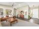 Inviting living room featuring high ceilings, slate floors, a patterned rug, and neutral paint at 9623 S 25Th Ln, Phoenix, AZ 85041