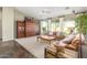 Spacious living room with built-in wooden shelving, a patterned rug, and lots of natural light at 9623 S 25Th Ln, Phoenix, AZ 85041