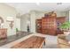 This living room has slate floors, a patterned rug, built-in wooden shelving, and neutral paint at 9623 S 25Th Ln, Phoenix, AZ 85041