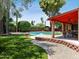 Beautiful backyard with a pool, patio, and lush green lawn perfect for entertaining at 1 W Canterbury Ln, Phoenix, AZ 85023