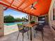 Backyard patio with ceiling fan, dining table, and seating with pool view at 1 W Canterbury Ln, Phoenix, AZ 85023